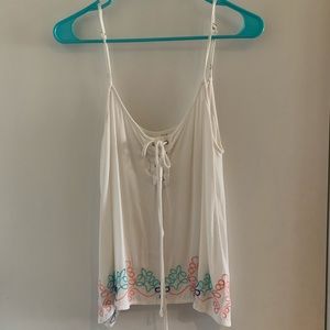 White tank with floral at the bottom